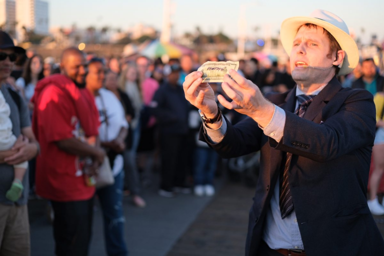 shaun performing magic at an outside location.